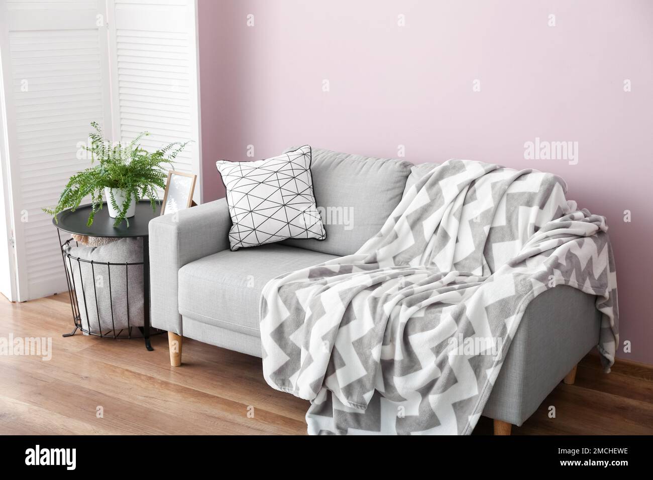 Interior of stylish living room with grey sofa and table Stock Photo ...