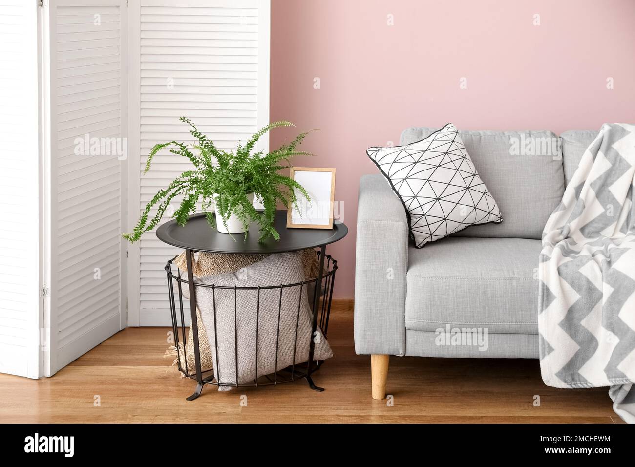 Interior of stylish living room with grey sofa and table Stock Photo