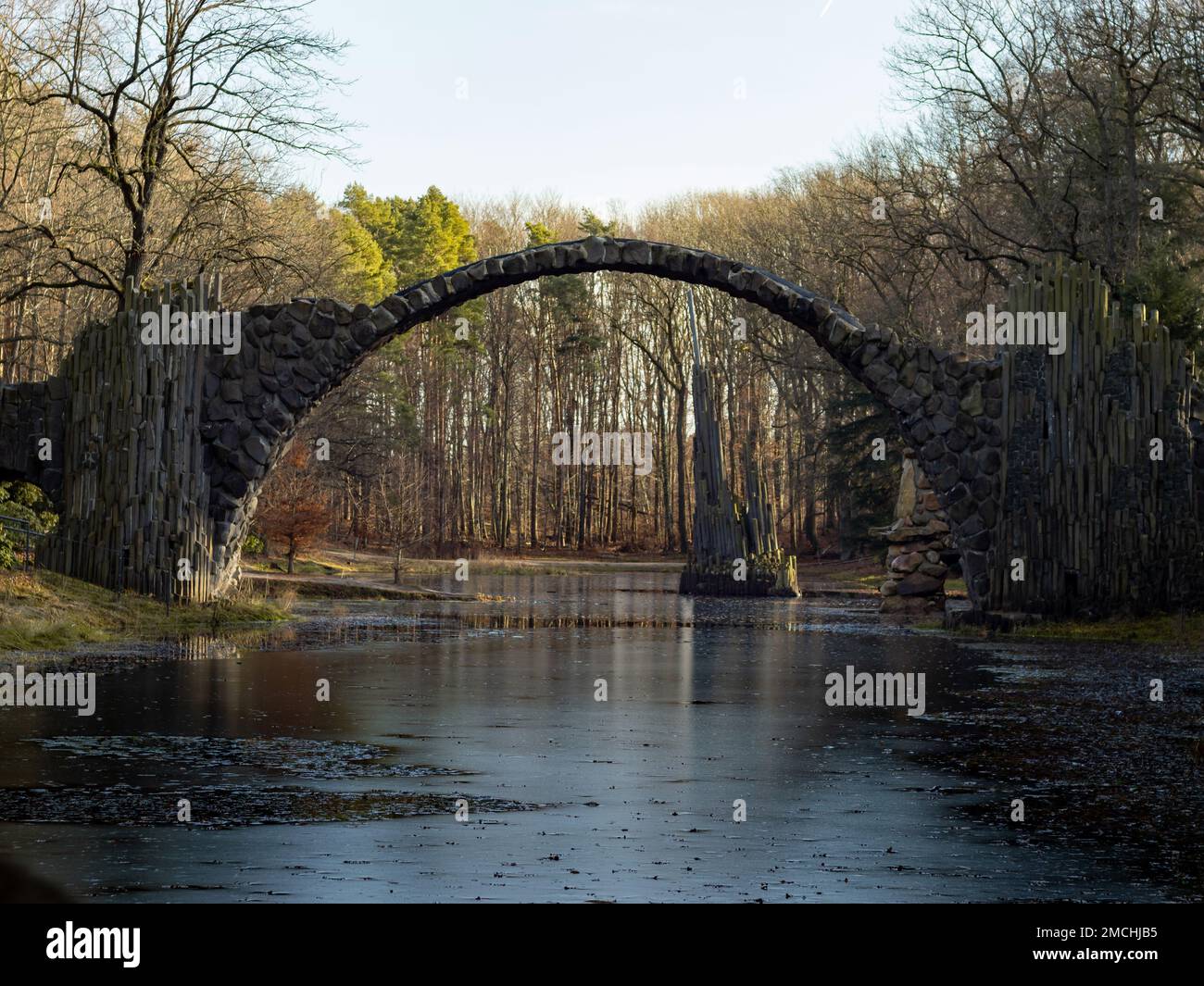 The Rakotz Bridge also known as Devil's Bridge in Germany. The old stone building is a travel destination for tourists. The architecture is mysterious Stock Photo