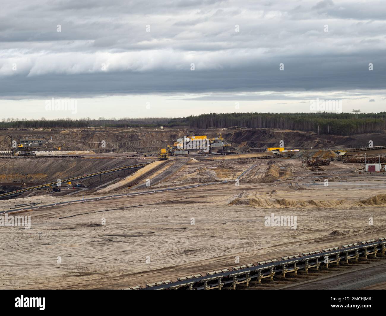 Large open pit mine for the exploitation of lignite. Mining brown coal in Welzow. Transformation of the nature made by humans in the Anthropocene. Stock Photo