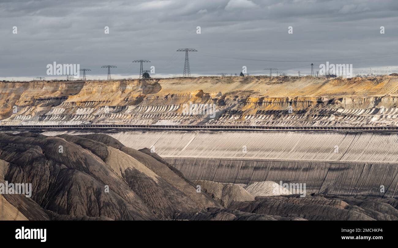 Landscape of an open pit mine for brown coal exploitation. Destroyed nature caused by human made transformations. No trees and no animals anymore. Stock Photo
