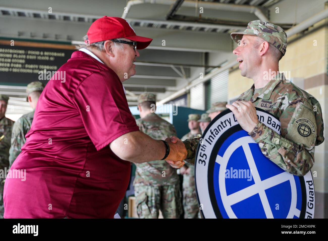 A Soldier assigned to the 35th Infantry Division Band, meets with members of the crowd before playing the national anthem at the Kansas City Monarchs baseball game, July 3rd, 2022. The 35th ID band is currently headquartered in Olathe, Kansas, and is the official band of the Kansas Army National Guard. The performance was part of a three-week tour, where the band performed at venues across the state. Stock Photo