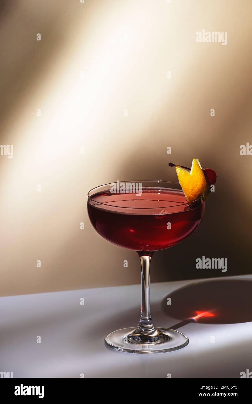 New Yorker cocktail with whiskey, grenadine, bitters, lemon juice and ice, garnished with lemon