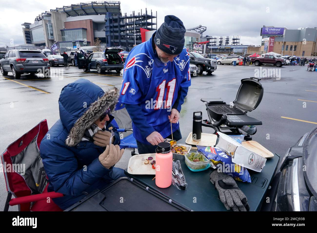 New England Patriots fan Barry Slotnick, right, tailgates with his