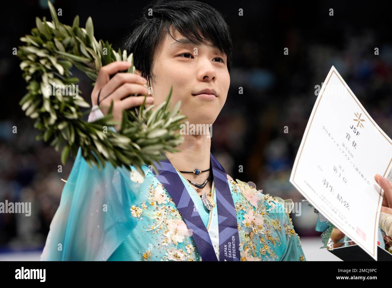 Yuzuru Hanyu of Japan celebrates during the victory ceremony of men's