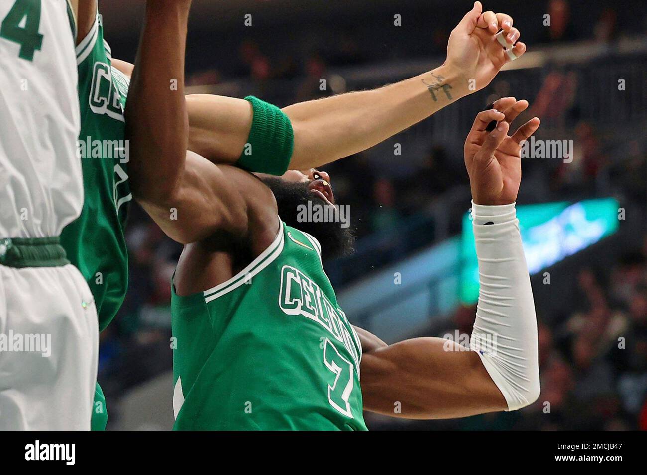 Boston Celtics forward Jayson Tatum, center, chips the tooth of guard