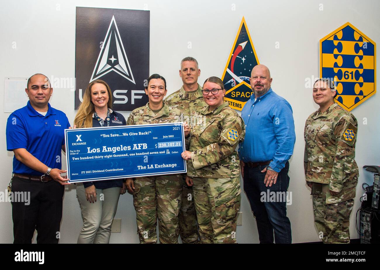 Mr. Leo Aguado, Army & Air Force Exchange Service (AAFES) LA Service Business Manager, left, and Ms. Sunny Britt, AAFES LA Administrative Assistant, present a dividend check to Col Becky Beers, LA Garrison commander, for more than $237K on July 5, 2022 at Los Angeles Air Force  Base. The check represents a portion of the sales from Airmen, Guardians, civilians, retirees and family members who shop at the LA Exchange and who patronize vendors. Out of every dollar that is left over, after payroll and expenses are paid, some 60 cents goes to help fund MWR programs. The other portion goes into a c Stock Photo