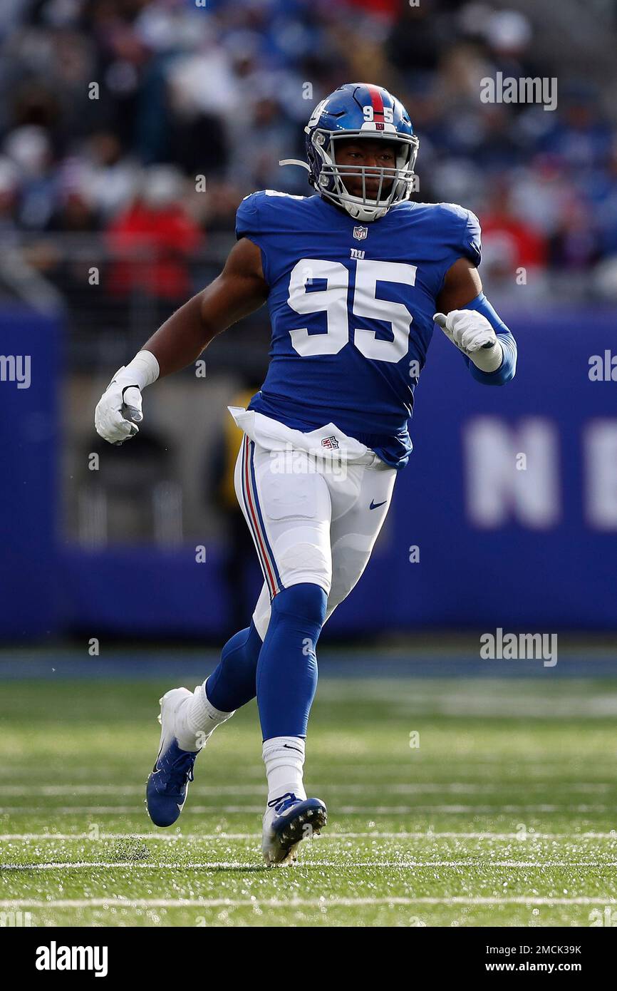 New York Giants outside linebacker Quincy Roche (95) runs up the field  during an NFL football game against the Dallas Cowboys, Sunday, Dec. 19,  2021, in East Rutherford, N.J. The Dallas Cowboys