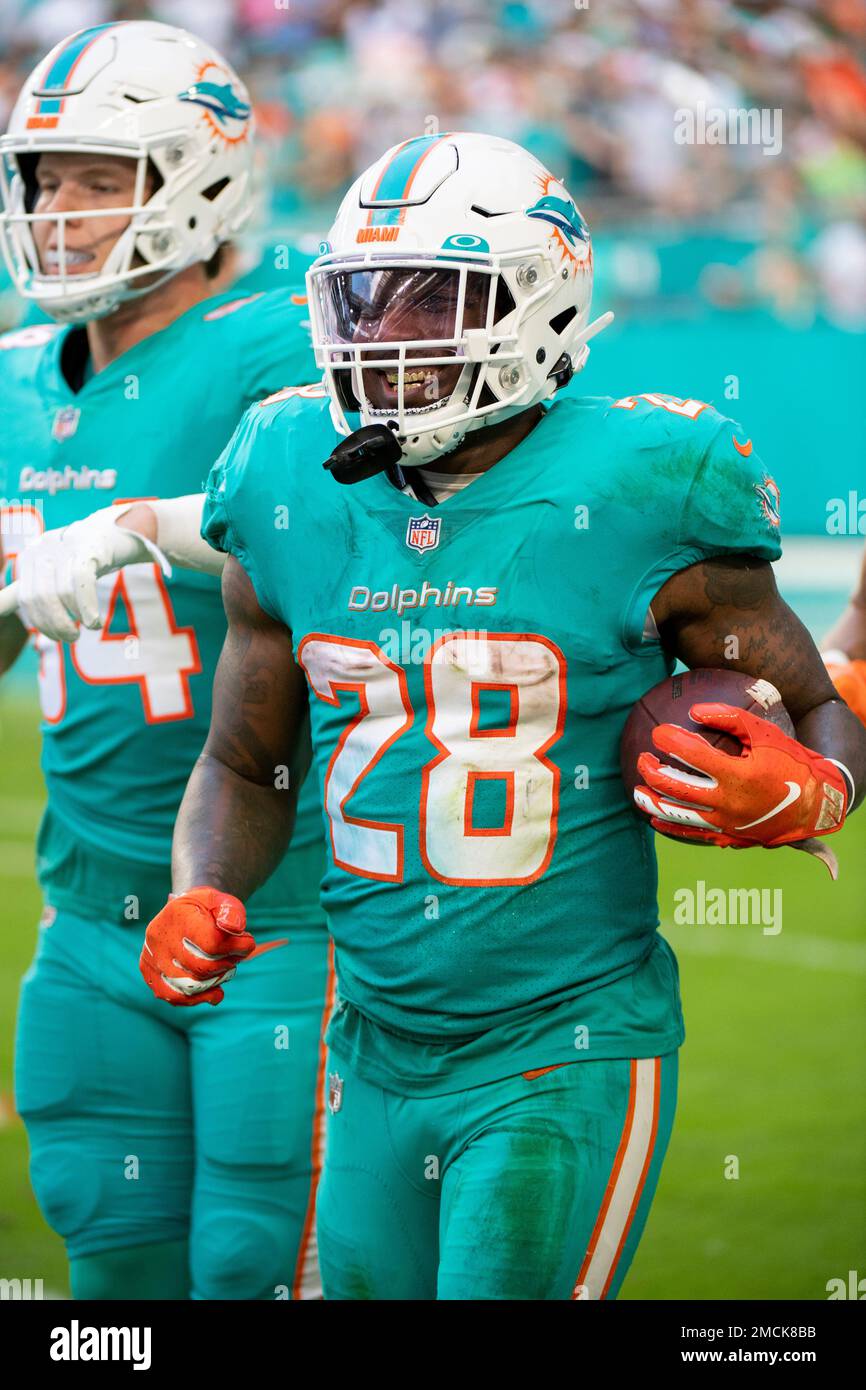 Miami Dolphins running back Duke Johnson (28) smiles as he celebrates  scoring a touchdown during an NFL football game against the New York Jets,  Sunday, Dec. 19, 2021, in Miami Gardens, Fla. (