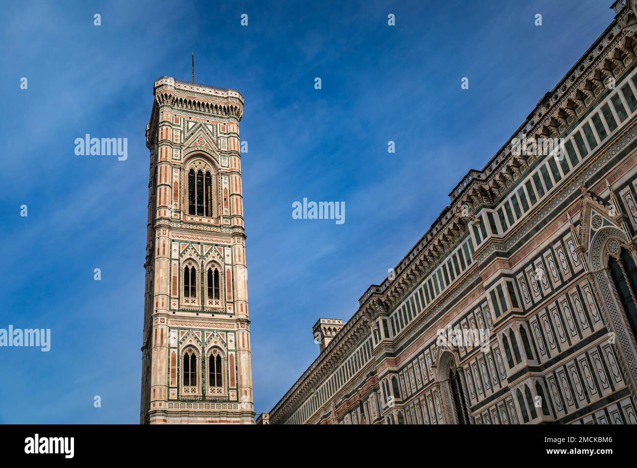 Colored marble facade of the Giotto Campanile bell tower and the Duomo Cathedral or Cattedrale di Santa Maria del Fiore complex in Florence, Italy Stock Photo