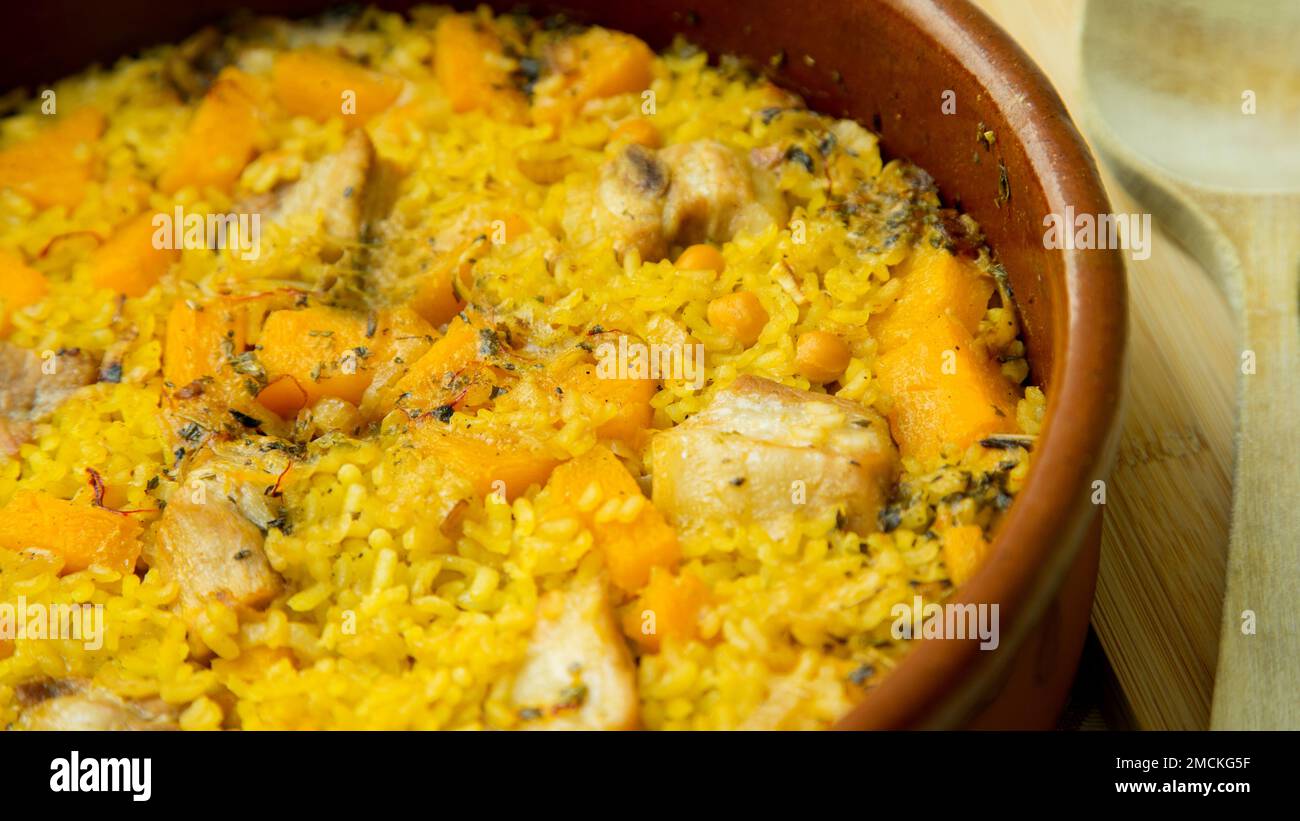 Original spanish paella recipe with meat cooked in a casserole in the