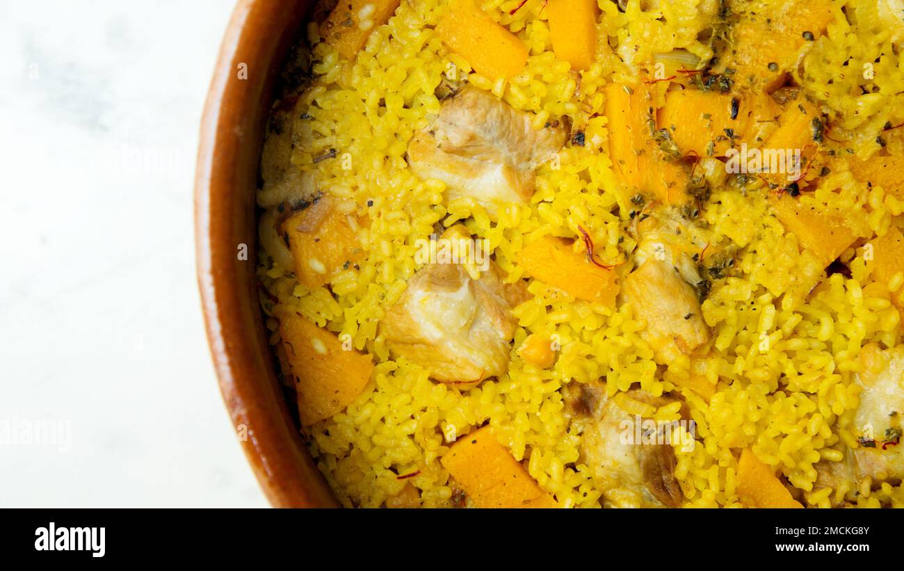 Original spanish paella recipe with meat cooked in a casserole in the