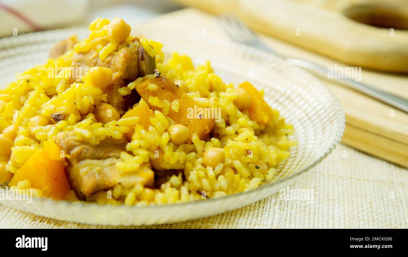 Original spanish paella recipe with meat cooked in a casserole in the