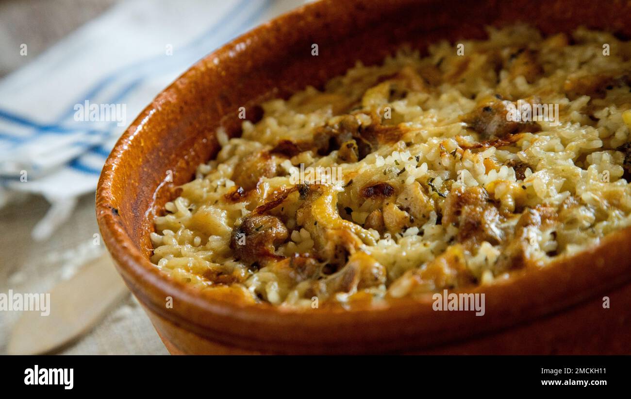 Original spanish paella recipe with meat cooked in a casserole in the