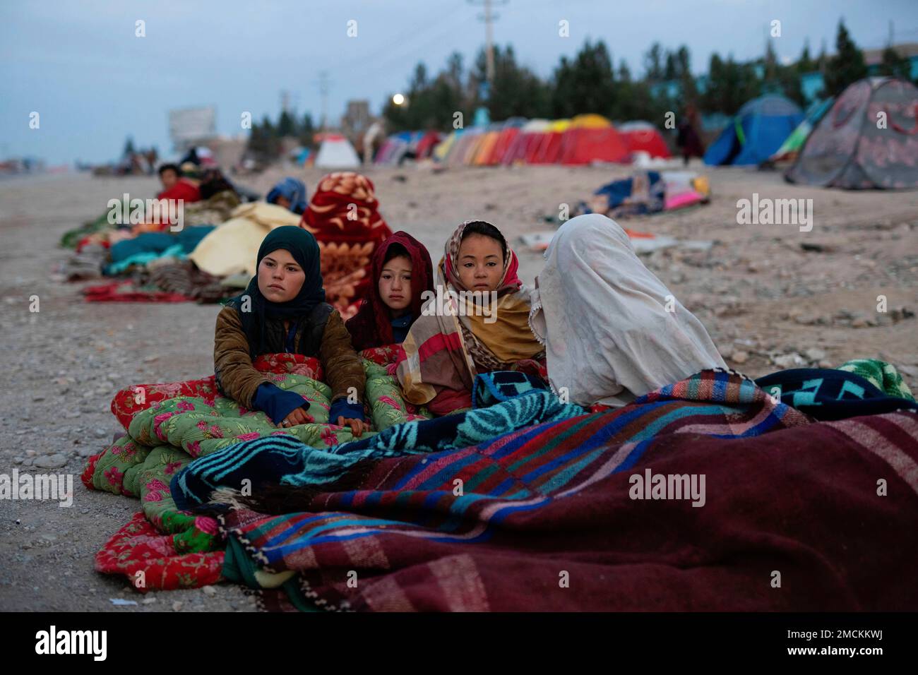 FILE Afghan children are covered with a blanket as their families