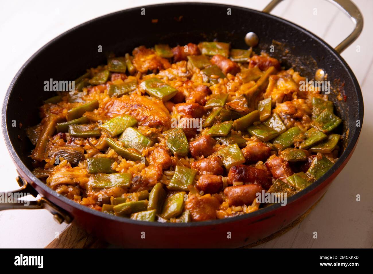 Original spanish paella recipe with sausage pork and vegetables Stock