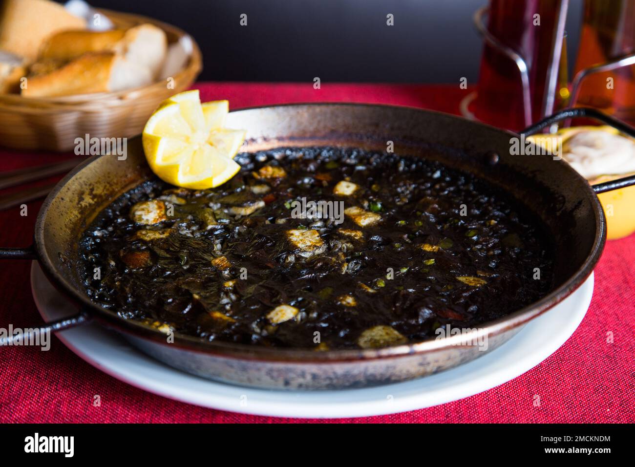 Original spanish black paella recipe with seafood Stock Photo Alamy