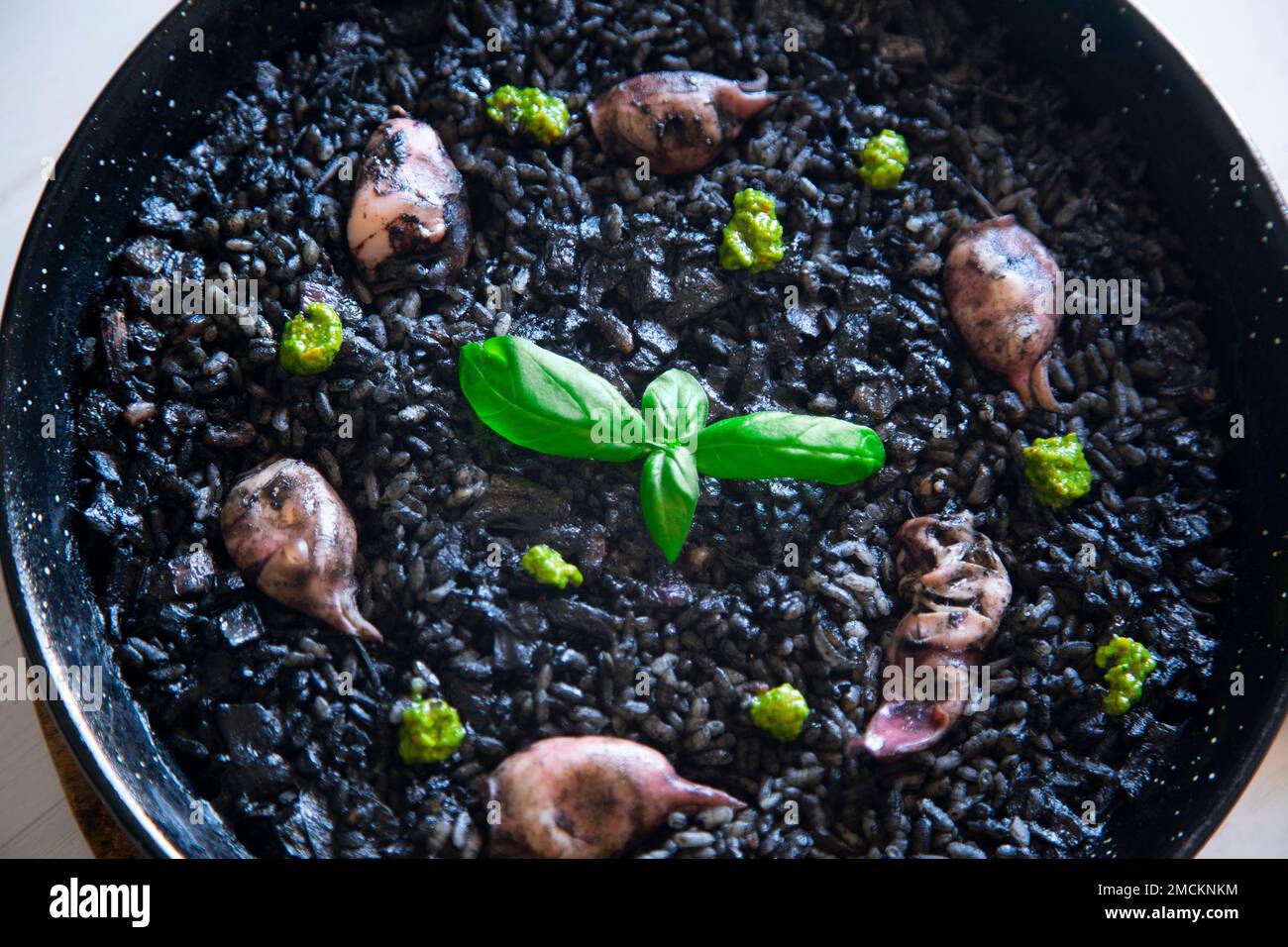Original spanish black paella recipe with seafood Stock Photo Alamy