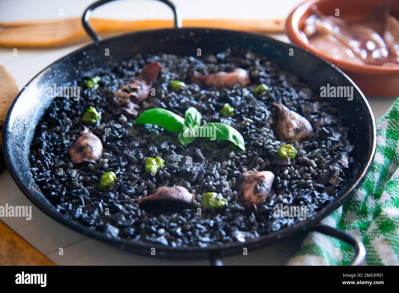 Original spanish black paella recipe with seafood Stock Photo Alamy