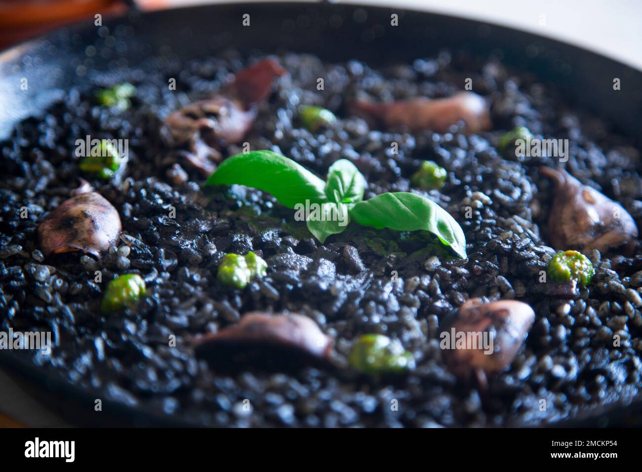 Original spanish black paella recipe with seafood Stock Photo Alamy
