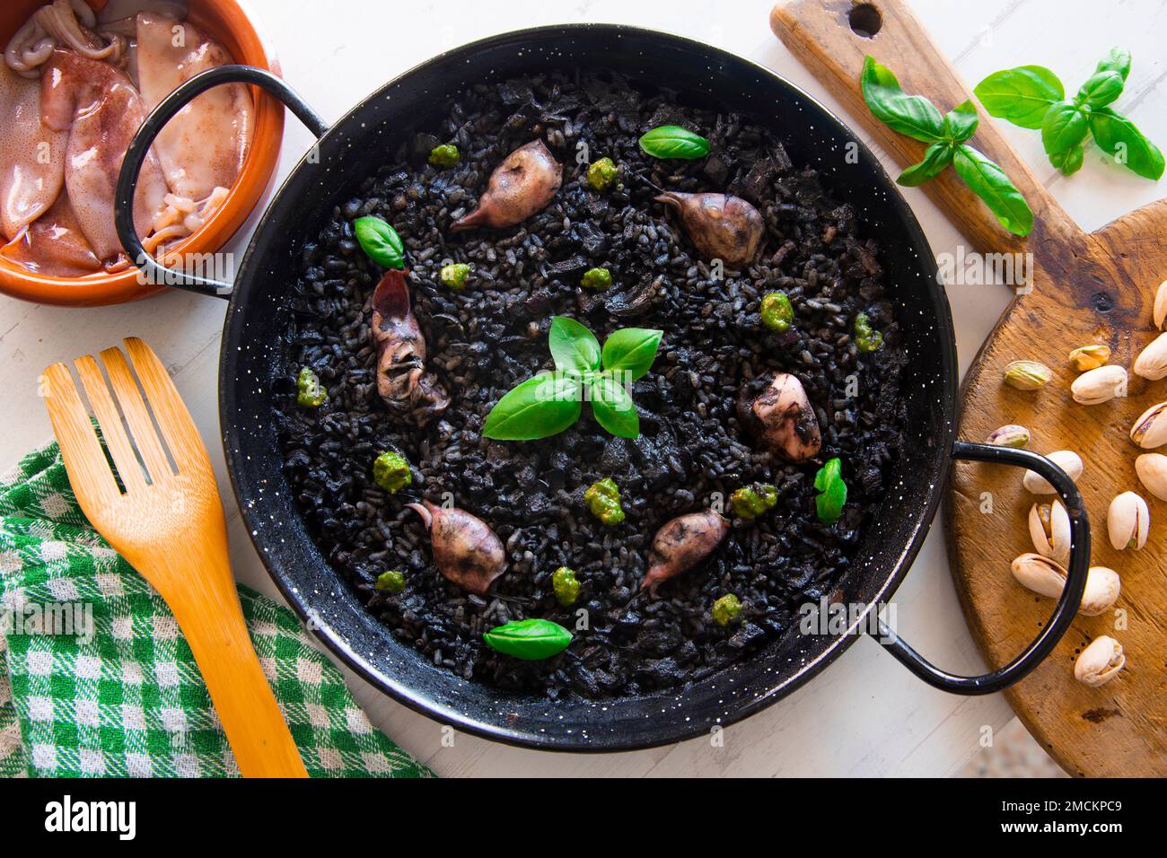 Original spanish black paella recipe with seafood Stock Photo Alamy