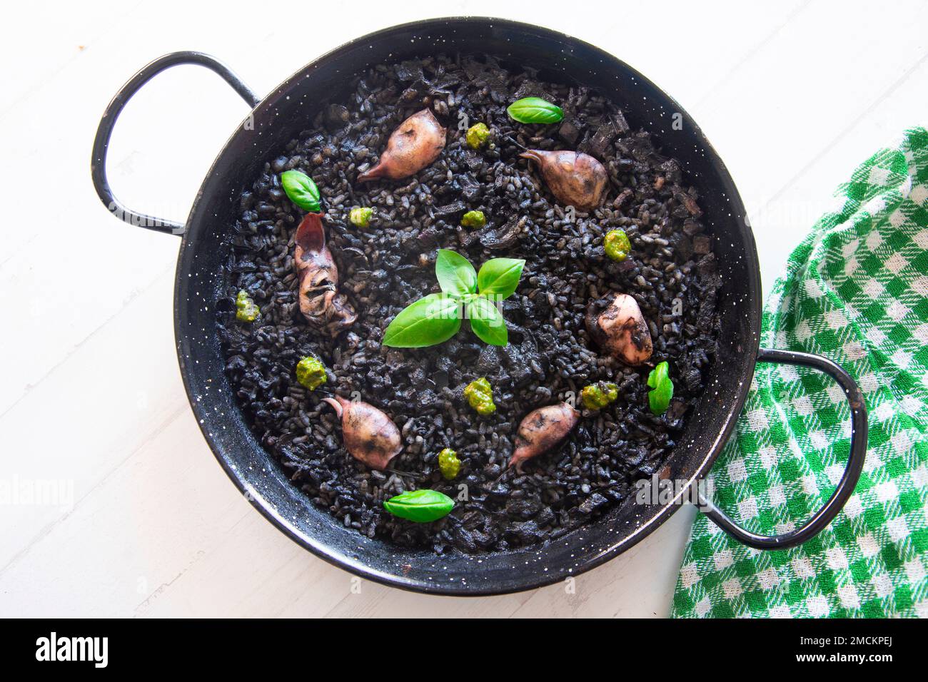 Original spanish black paella recipe with seafood Stock Photo Alamy