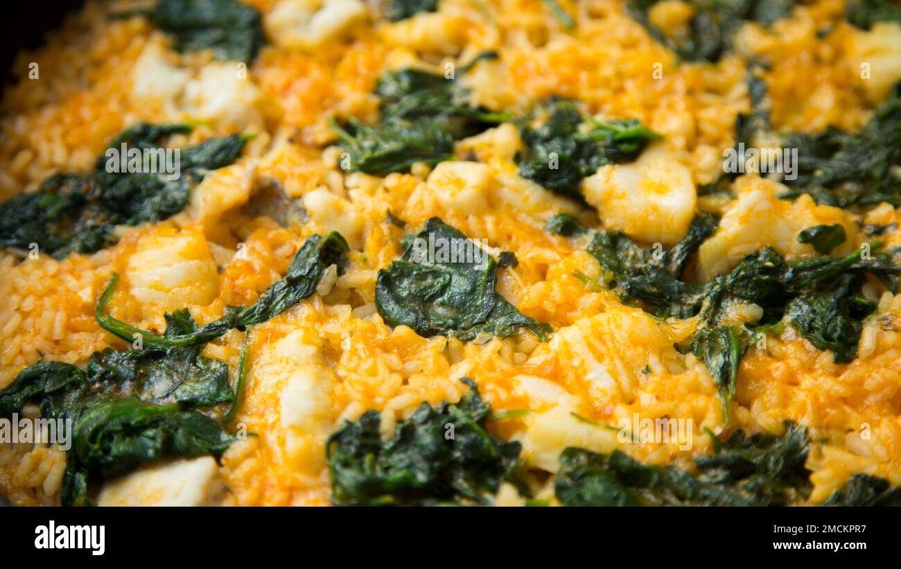 Original spanish paella recipe with monk fish and spinach Stock Photo