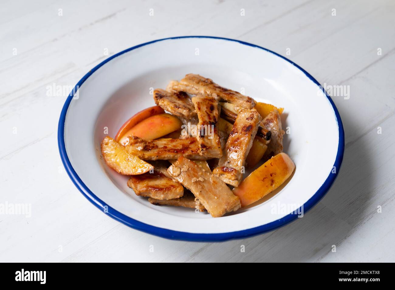 Pork loin cooked with apple. Traditional spanish tapa Stock Photo Alamy