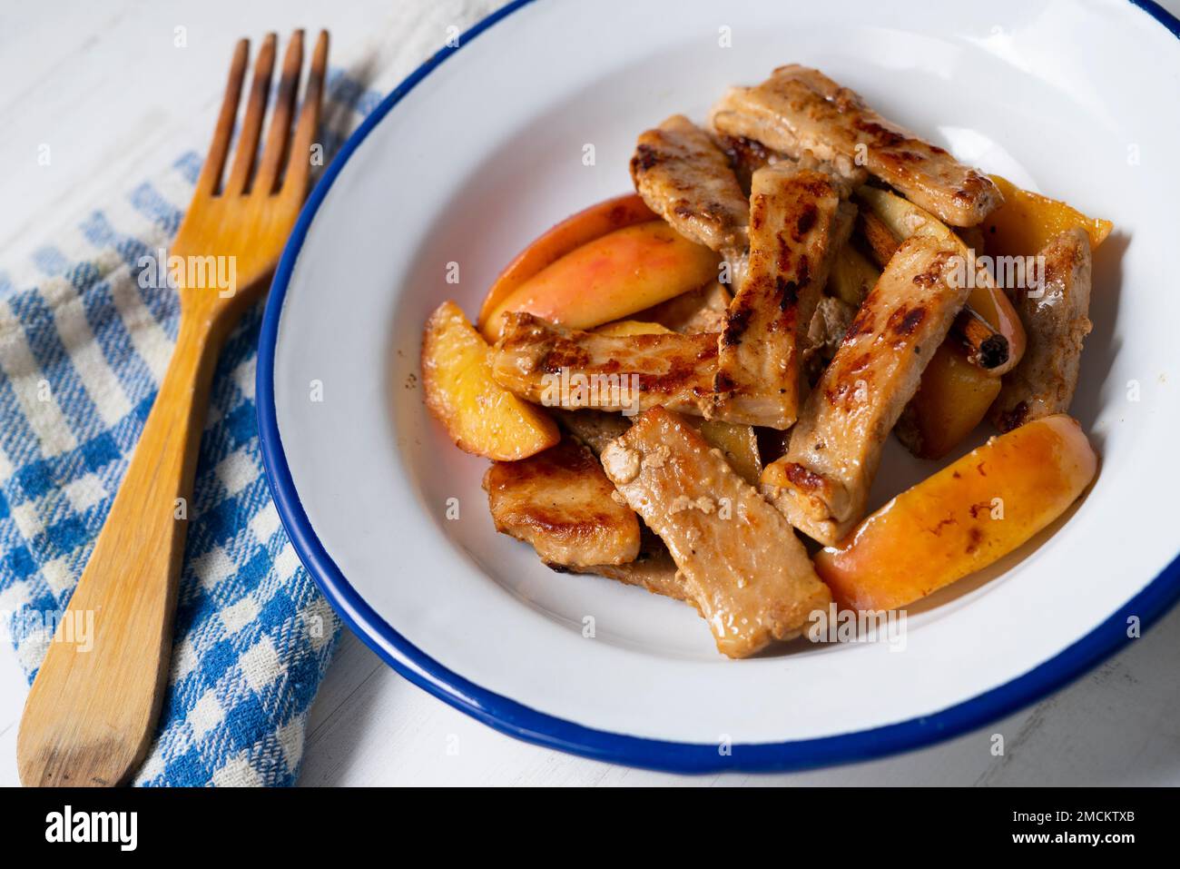 Pork loin cooked with apple. Traditional spanish tapa Stock Photo Alamy