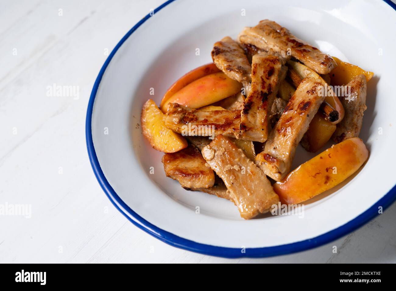 Pork loin cooked with apple. Traditional spanish tapa Stock Photo Alamy