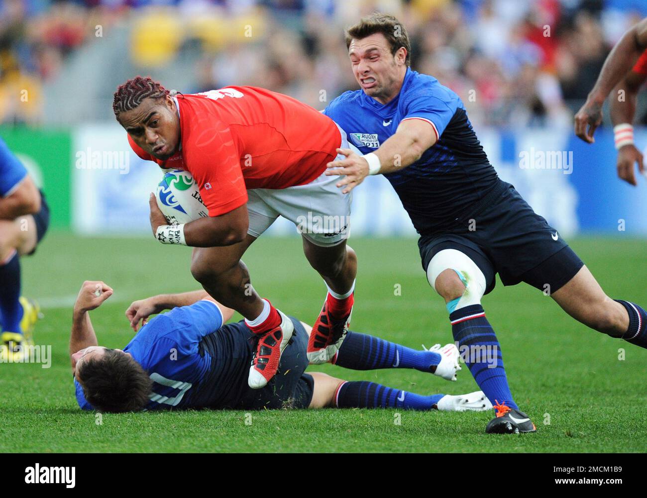 FILE - Tonga's Taniela Moa runs past France's Vincent Clerc during their  Rugby World Cup match in Wellington, New Zealand, Saturday Oct. 1, 2011.  Moa, a scrumhalf who almost was a New