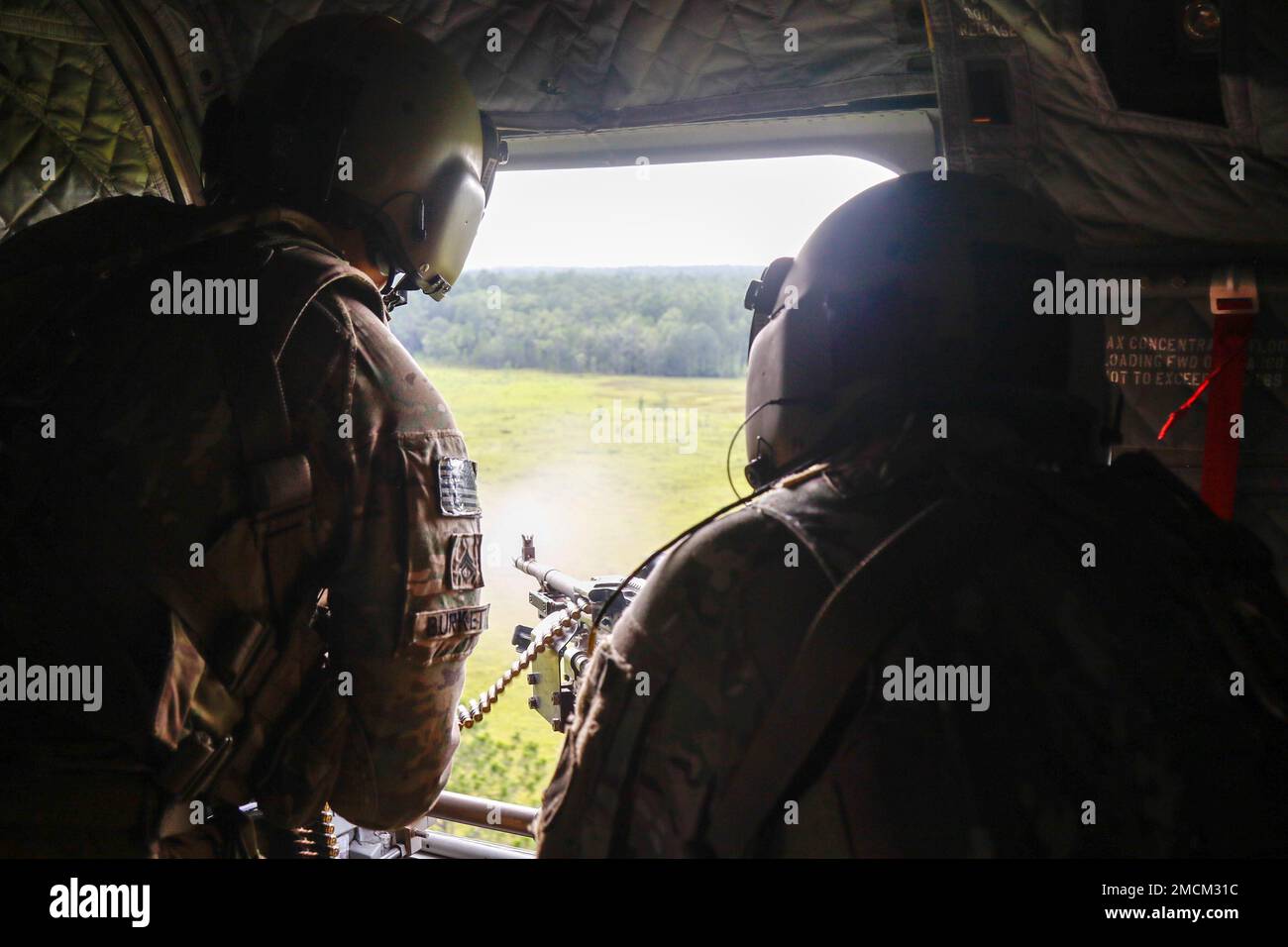 Soldiers assigned to 2nd Battalion, 3rd General Support Aviation Battalion, 3rd Combat Aviation Brigade, 3rd Infantry Division, shoot a M240H Machine Gun during aerial gunnery at Fort Stewart, Georgia, July 6, 2022. Soldiers must fire from the ground and aircraft to be fully qualified on their weapons system. Stock Photo