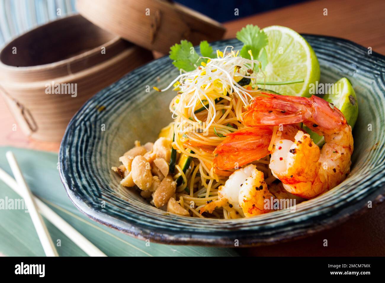 Pad thai, pad thai or pad thai, is a stir-fried rice noodle dish often served as street food in Thailand as part of the country's cuisine. Stock Photo