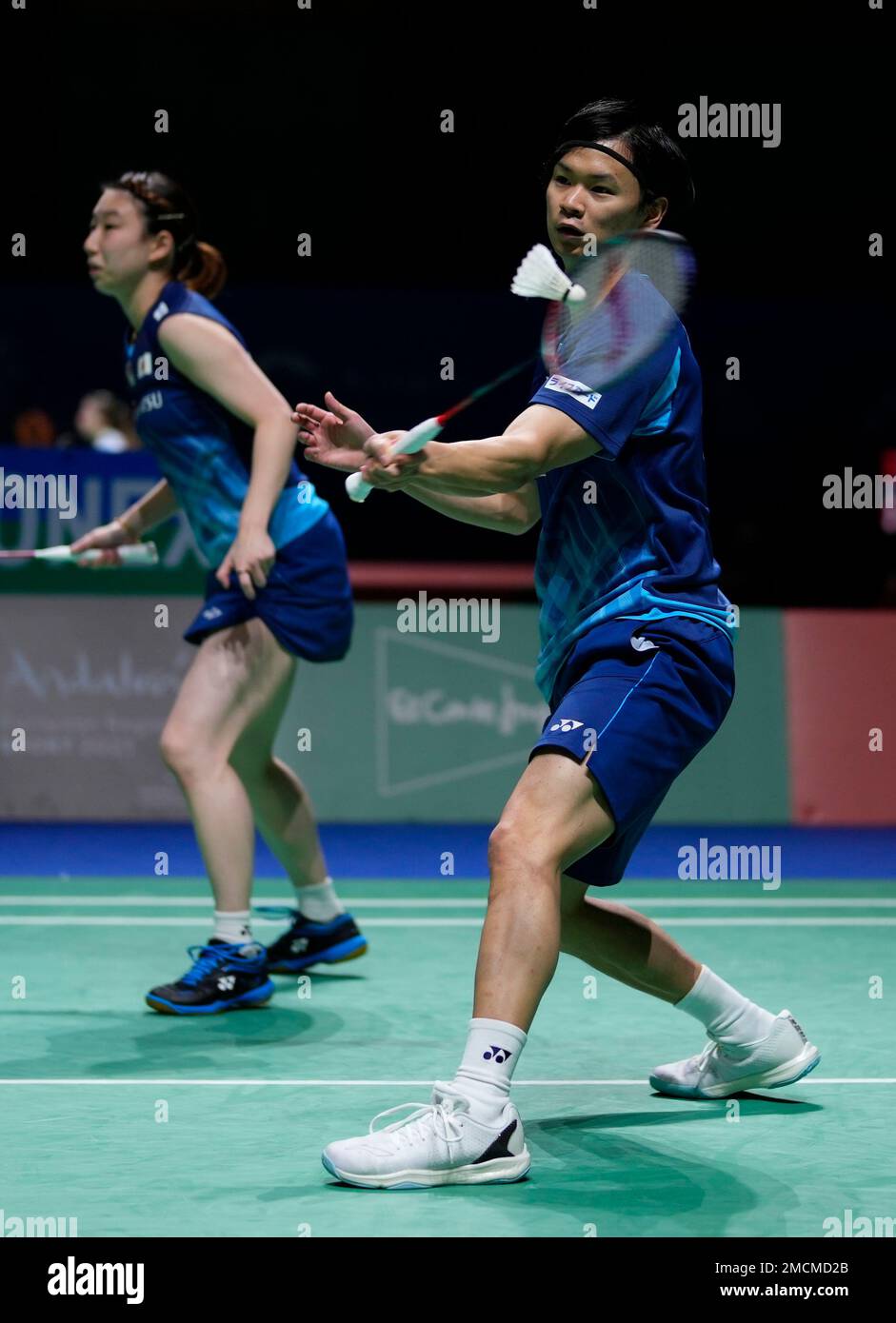 Yuta Watanabe of Japan, right, playing alongside Arisa Higashini returns to  the national Russian Federation players Evhenij Dremin and Evenia Dimova  during their mixed badminton match at the BWF World Championships in