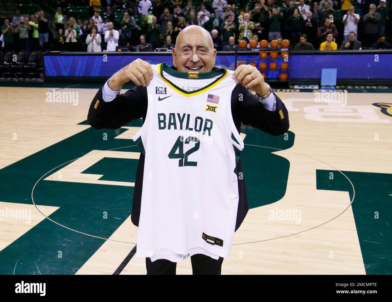 ABC/ESPN basketball analyst Dick Vitale is presented with a Baylor 42