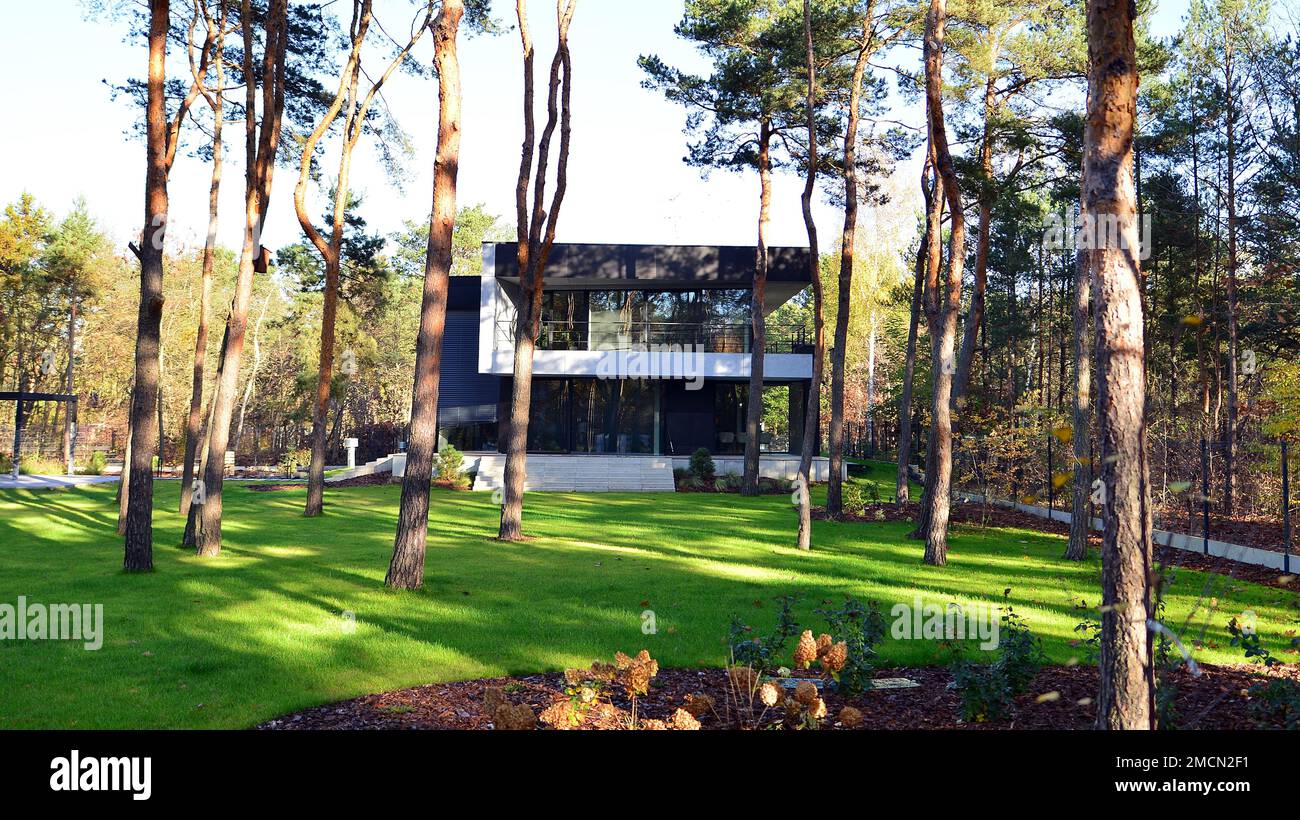 Modern villa with large patio in the woods. Modern design in a big residence in the middle of
