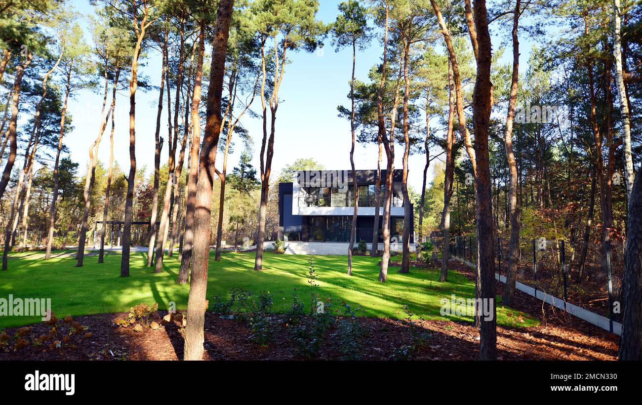Modern villa with large patio in the woods. Modern design in a big residence in the middle of