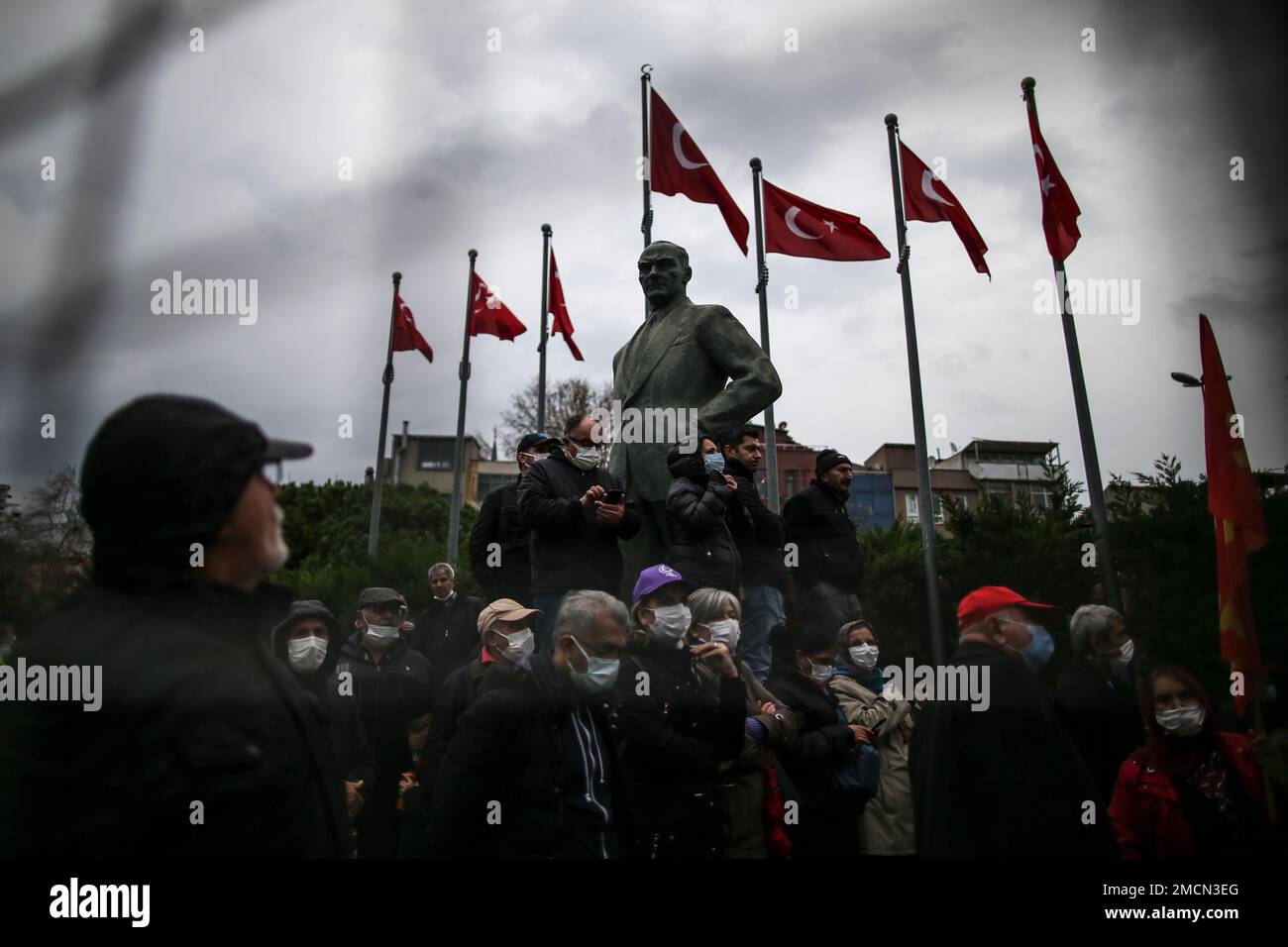People stand next to a statue of modern Turkey's founder Mustafa Kemal ...