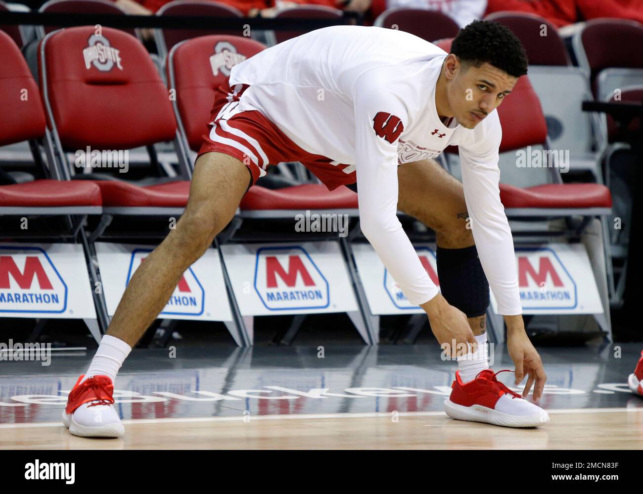 Wisconsin guard Jonathan Davis stretches before an NCAA college