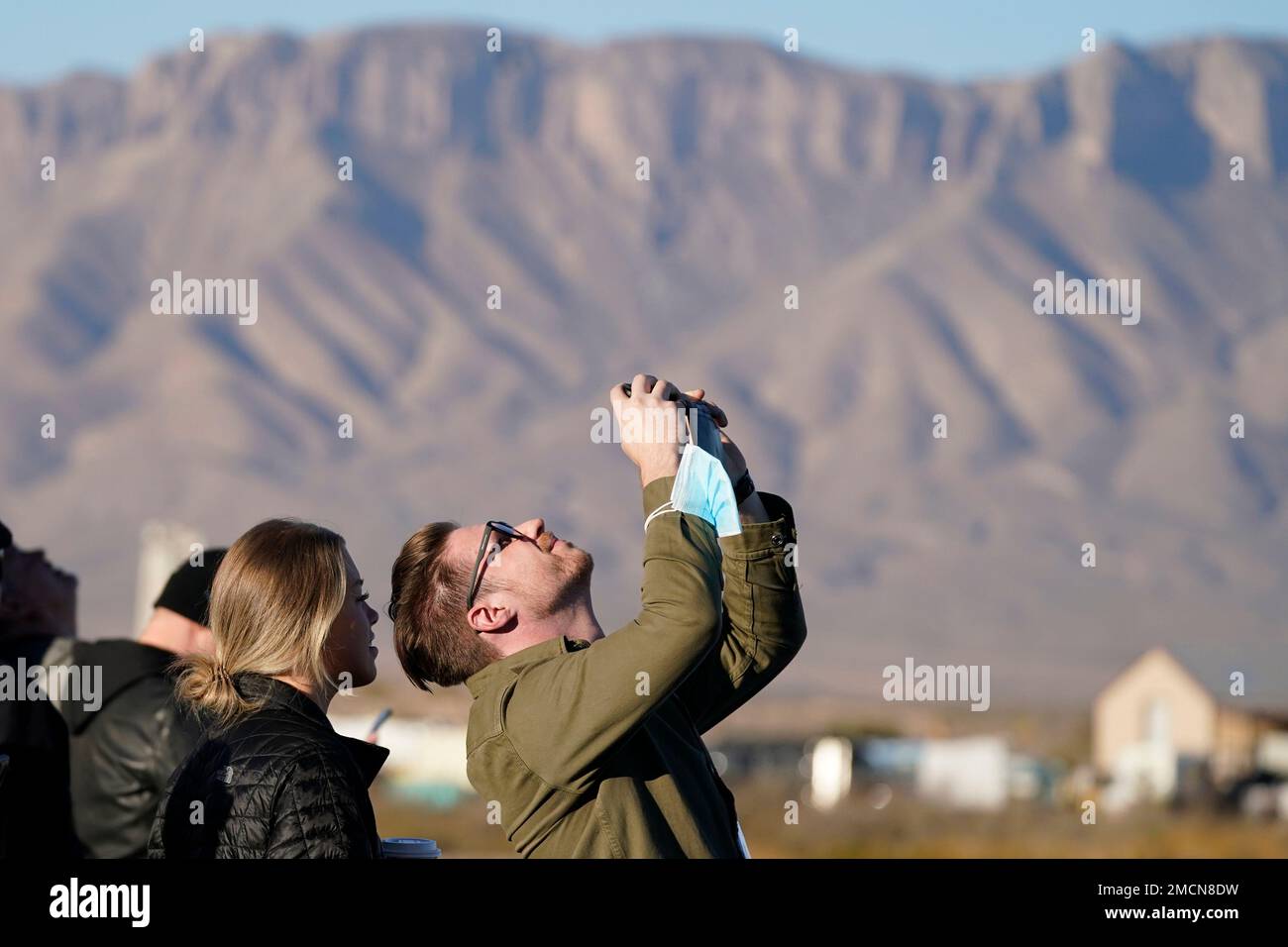 People watch the Blue Origin's New Shepard rocket launch from its
