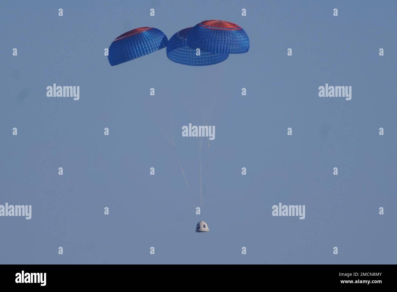 Parachutes carry the Blue Origin's New Shepard capsule to the ground