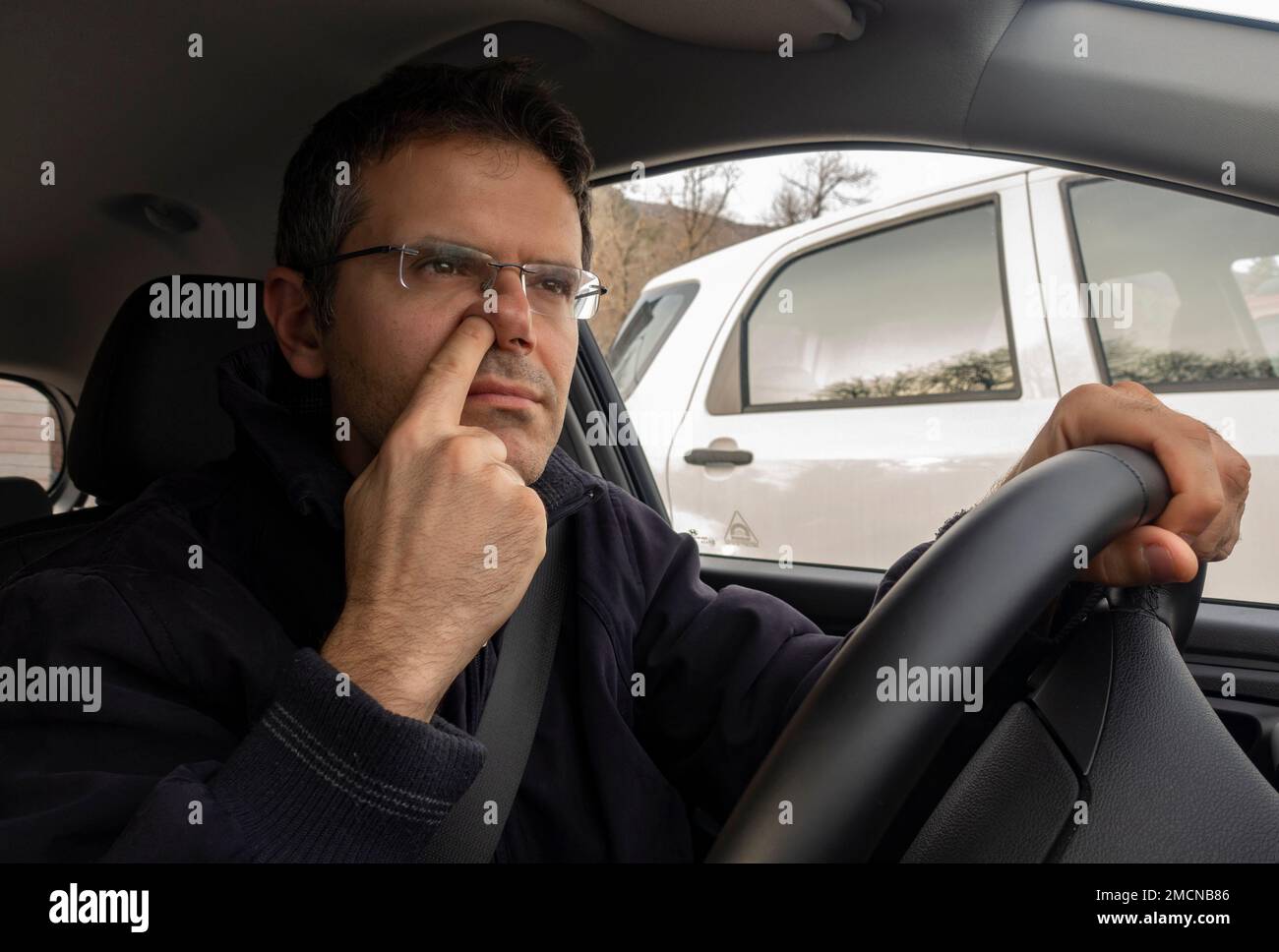 https://c8.alamy.com/comp/2MCNB86/man-in-car-with-finger-into-nose-while-driving-2MCNB86.jpg