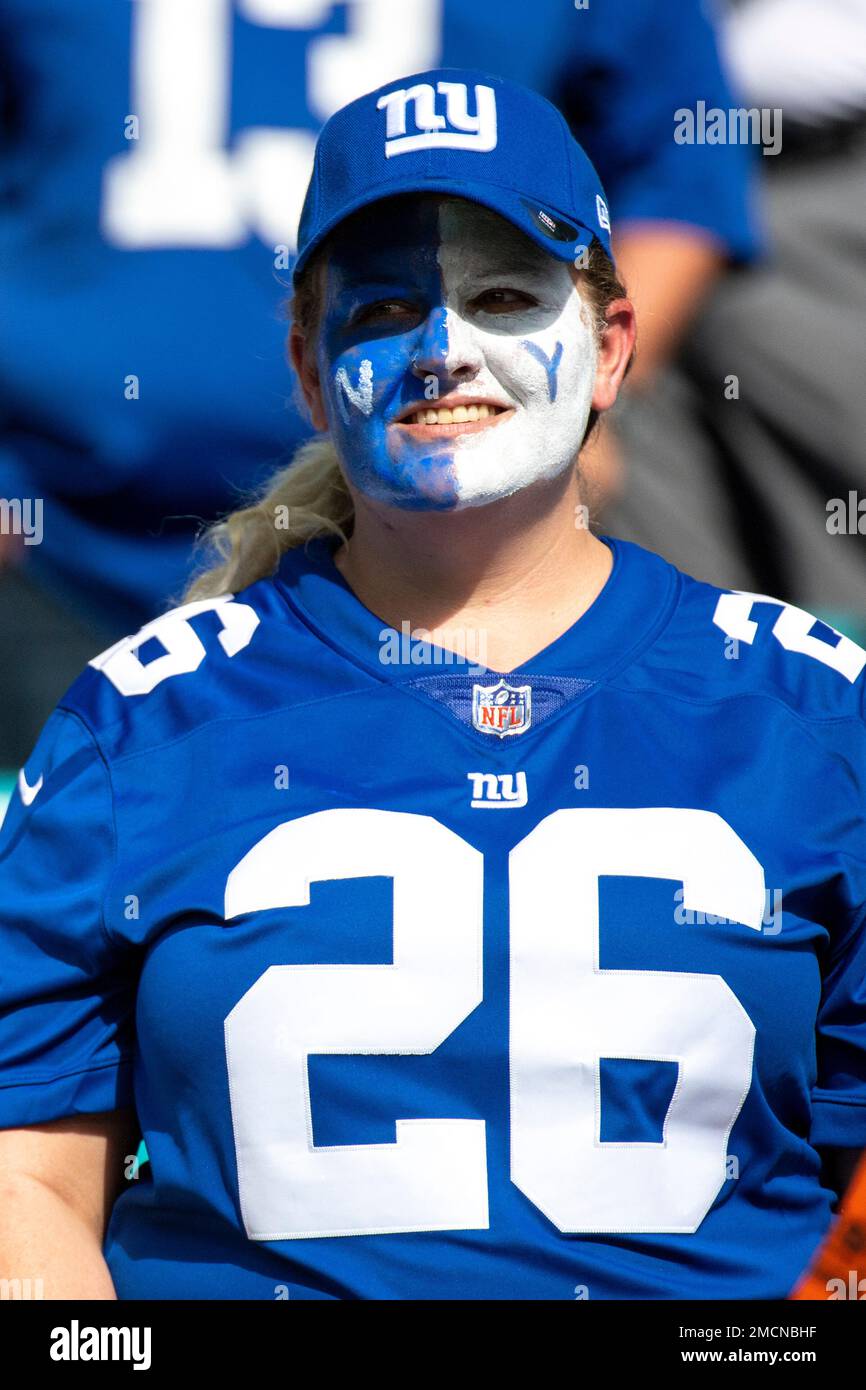 Female New York Giants fan wears face paint in the stands before the start  of an NFL football game against the Miami Dolphins, Sunday, Dec. 5, 2021,  in Miami Gardens, Fla. (AP