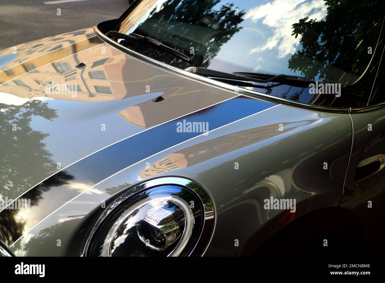 Shiny building reflection on Mini Cooper car bonnet Stock Photo