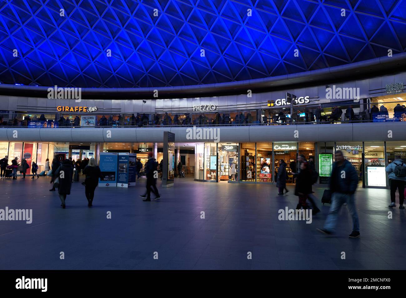 Travellers in the renovated interior of King's Cross rail station ...