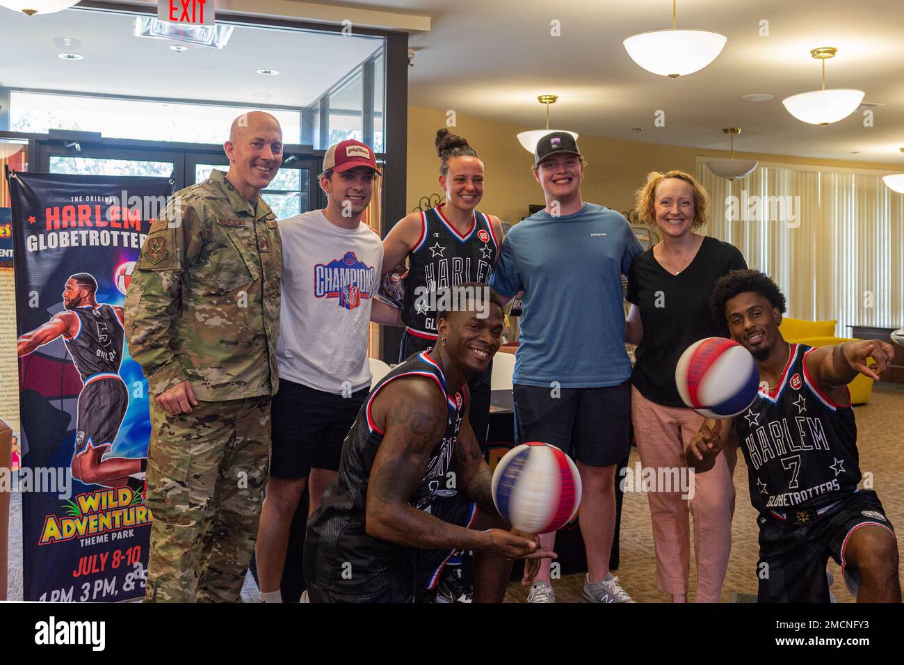 U.S. Air Force Col. Michael Gallagher, 23rd Mission Support Group commander, and his family pose for a photo with the Harlem Globetrotters during a visit at Moody Air Force Base, Georgia, July 7, 2022. Off the court, the Globetrotters make connections with local communities. Stock Photo