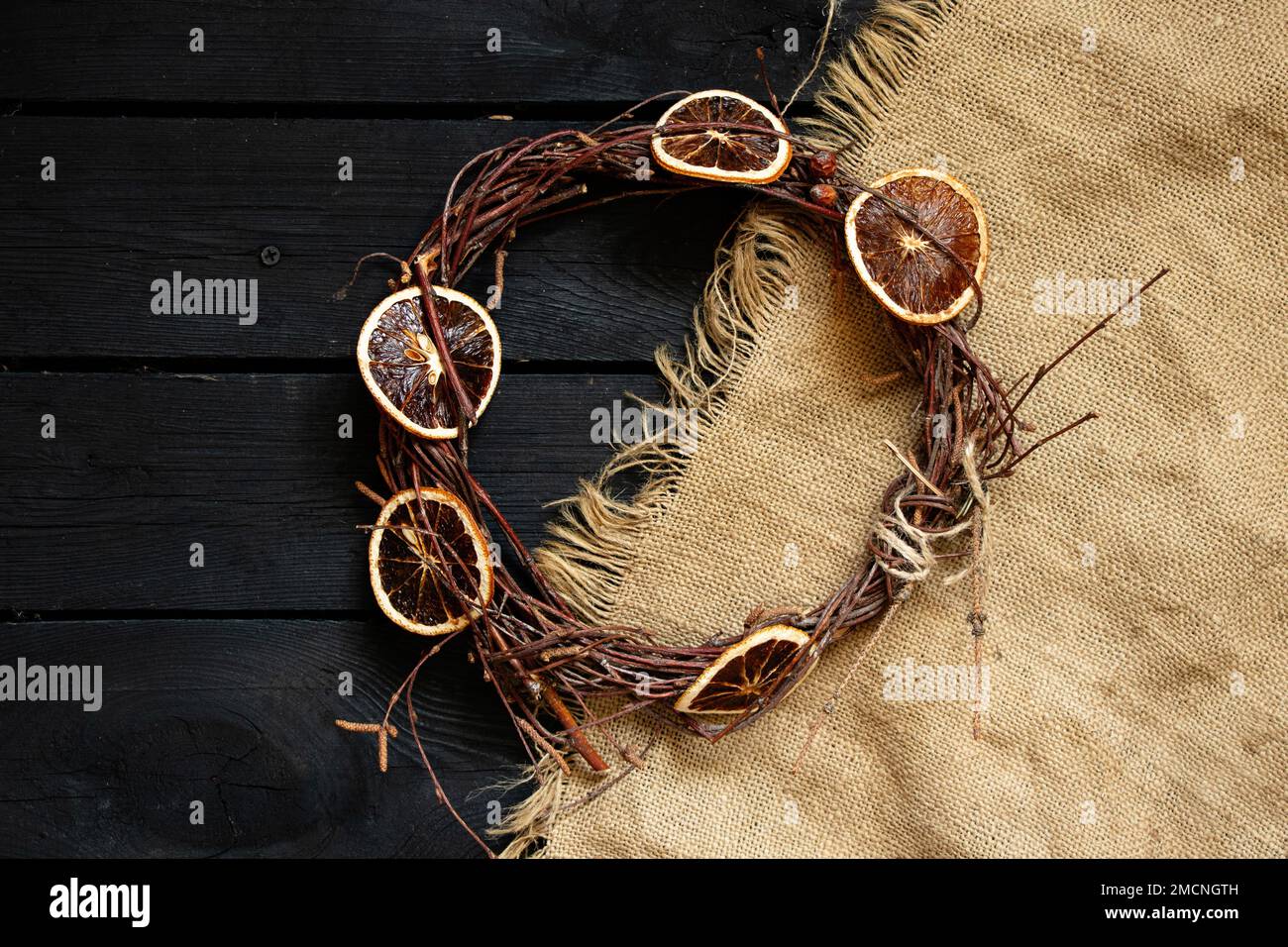 new year christmas wreath on an old wooden table, decor for the holiday, dry vine wreath Stock Photo