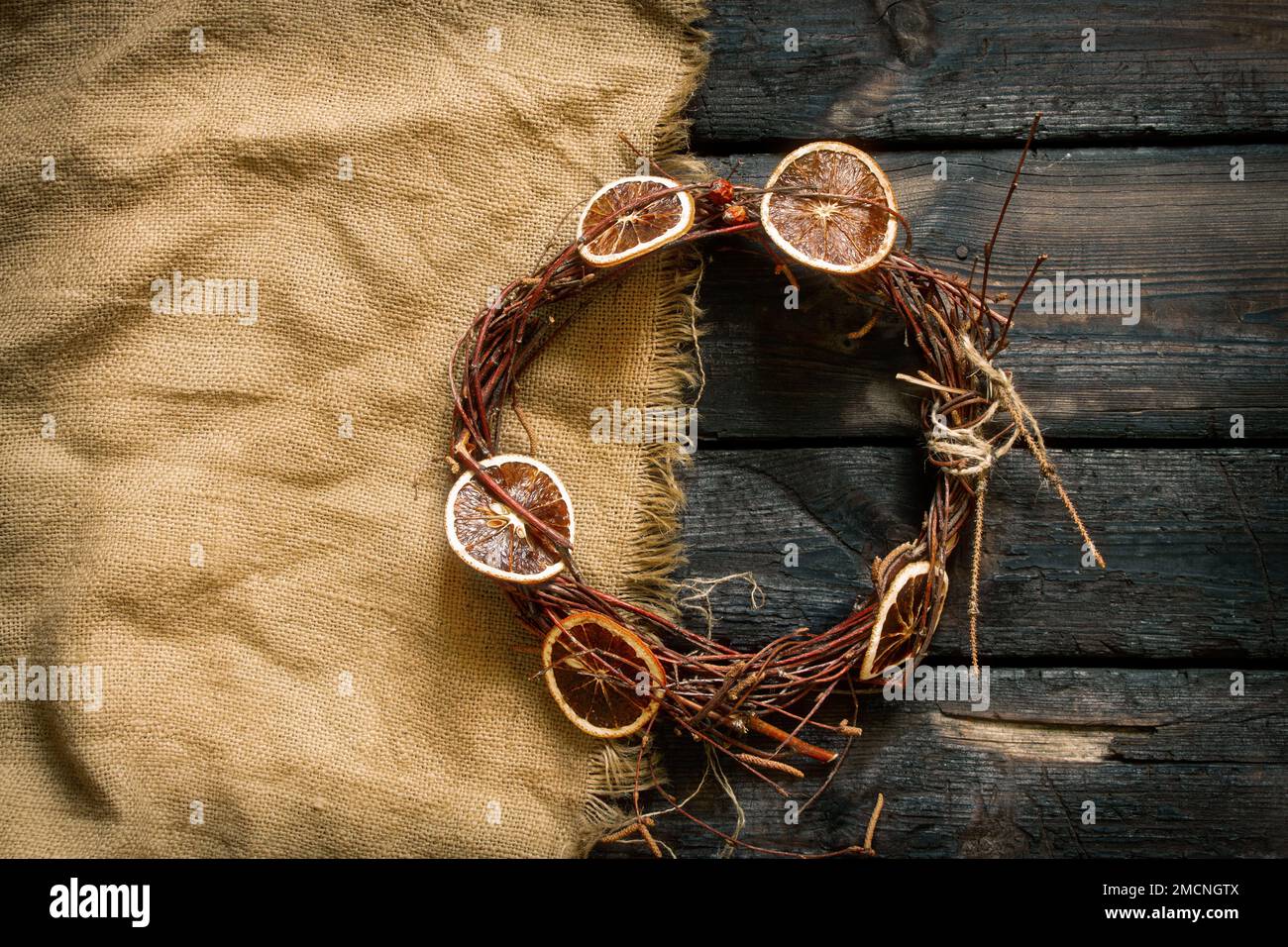 new year christmas wreath on an old wooden table, decor for the holiday, dry vine wreath Stock Photo