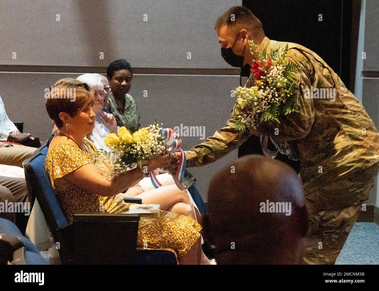 Andrea Thigpen is handed a bouquet of yellow roses during her husband’s change of commandant ceremony at the Soldiers Support Institute auditorium July 7, 2022. Col. Chesley D. Thigpen assumed the role of the 36th commandant of the Fort Jackson Adjutant General School and 23rd chief of the Adjutant General Corps. Stock Photo