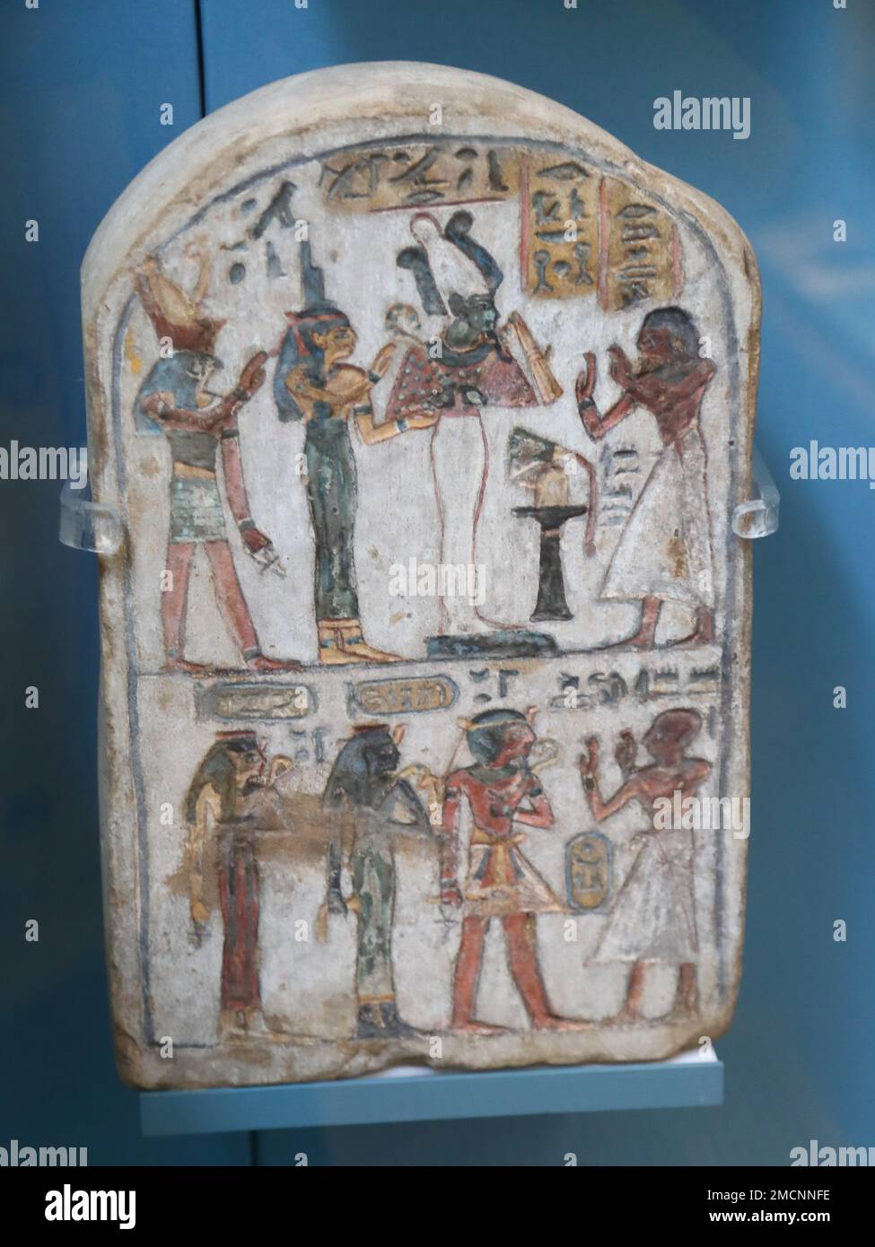 Egyptian painted limestone stela showing adoration of deceased members of the 18th Dynasty royal family at the British Museum, London, UK Stock Photo
